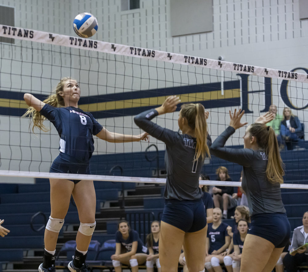 Abingdon's (8) Alexis Brown prepares to hit the ball over Hidden Valley's (1) Frannie Sine and (4) Abigail Atkins.